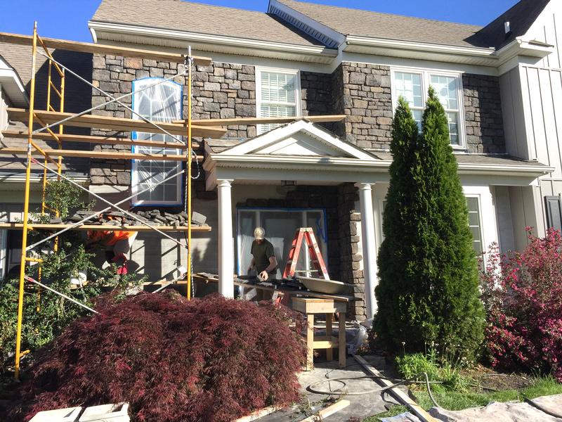 during stone veneer on front of home